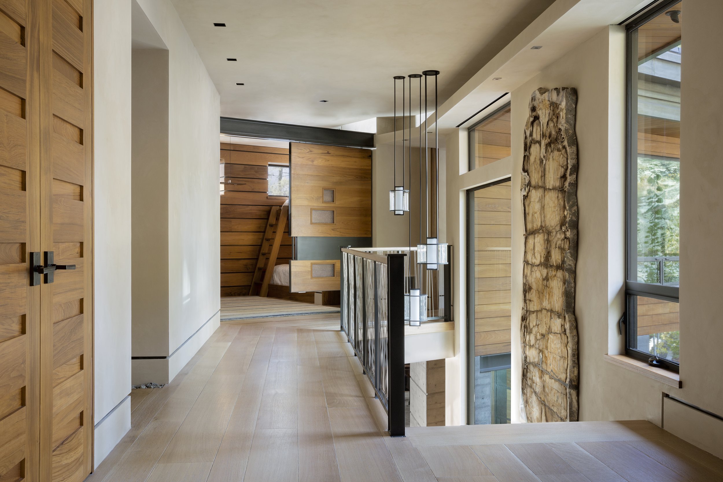 Modern Hallway with Light Wood Doors and Pendant Lights in McCall, Idaho Home