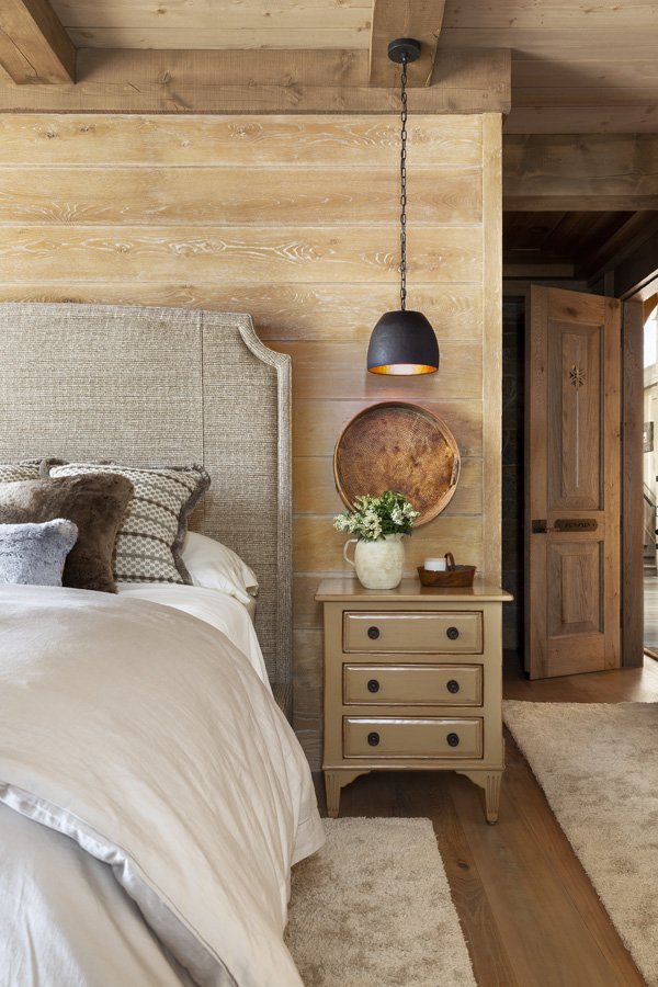 Rustic Bedroom with Wooden Nightstand and Decorative Lamp and Side Table in Mammoth Lakes, CA