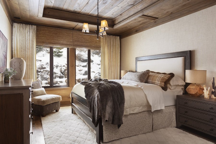 Modern Rustic Bedroom with Large Windows and Fur Bedding in Mammoth Lakes, CA