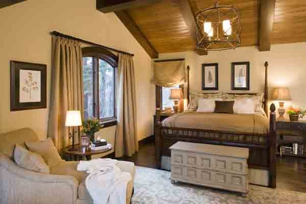 Rustic Primary Bedroom with Sitting Area and Bench and Large Window in Mammoth Lakes, CA