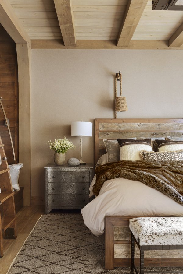 Modern Rustic Bedroom with Large Windows and Fur Bedding in Mammoth Lakes, CA